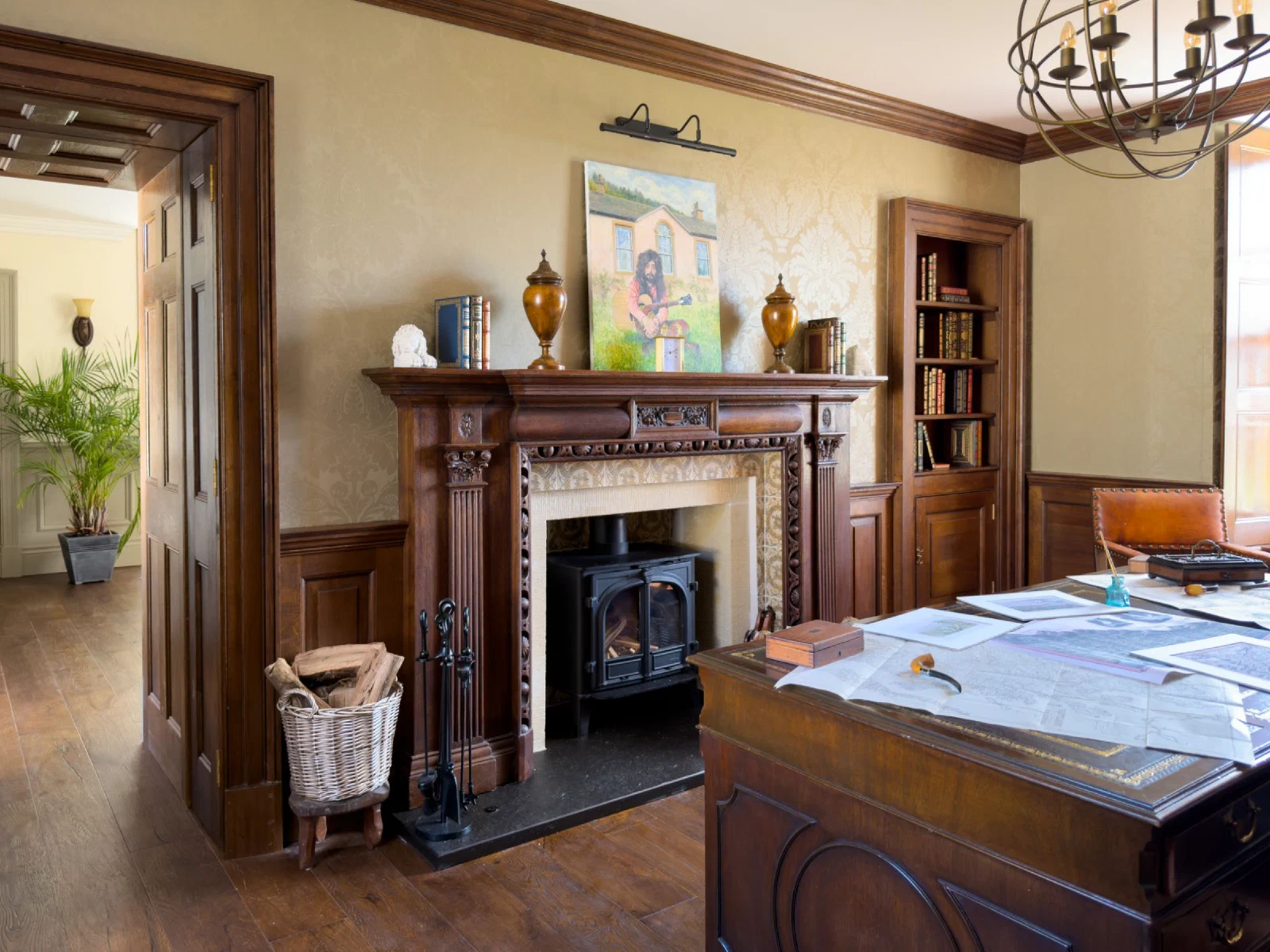 Carved oak chimneypiece with fluted pilasters and an enriched surround in the study at Reed Farmhouse