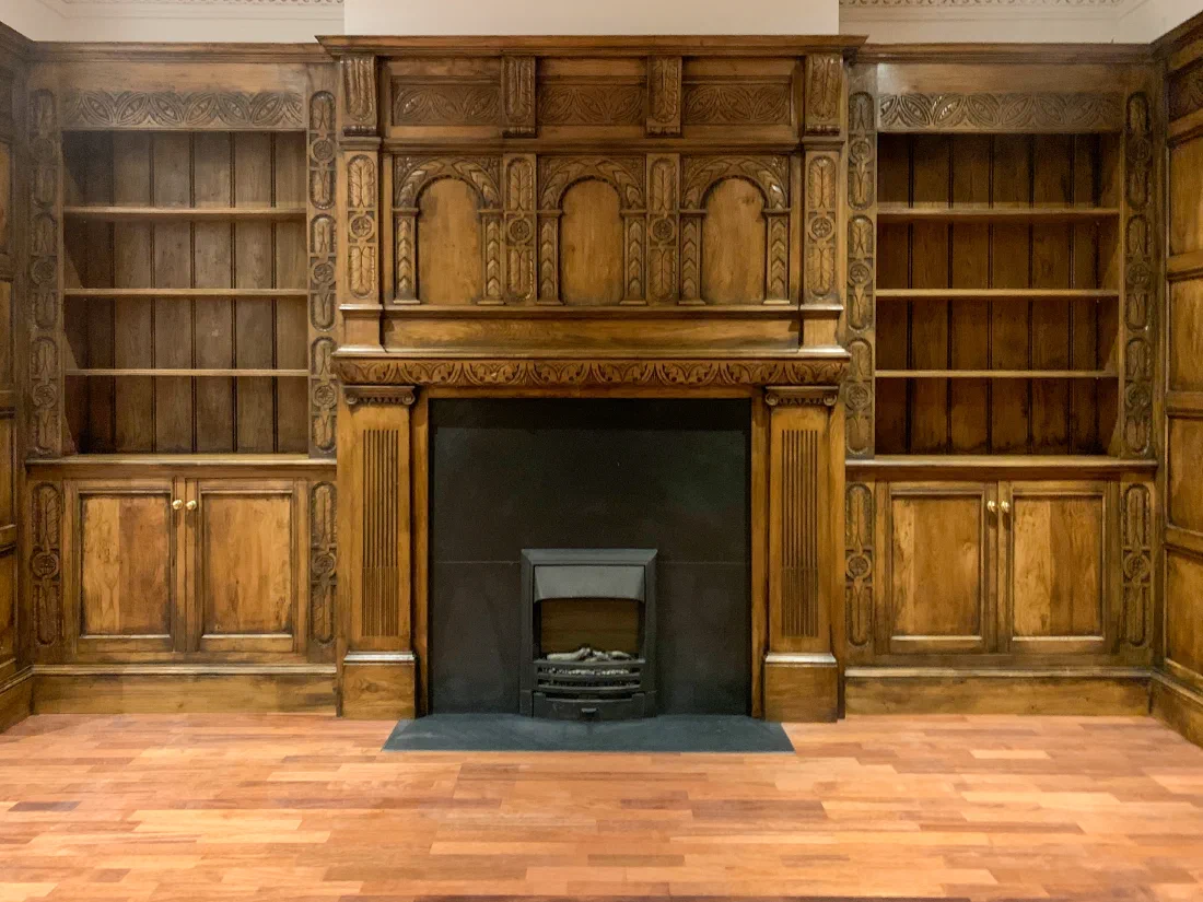 Timber fireplace and overmantel within a fitted library