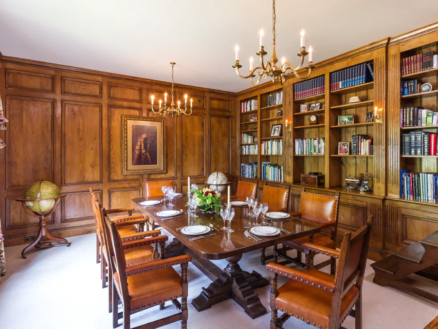 Panelled library and dining room with fitted bookcases