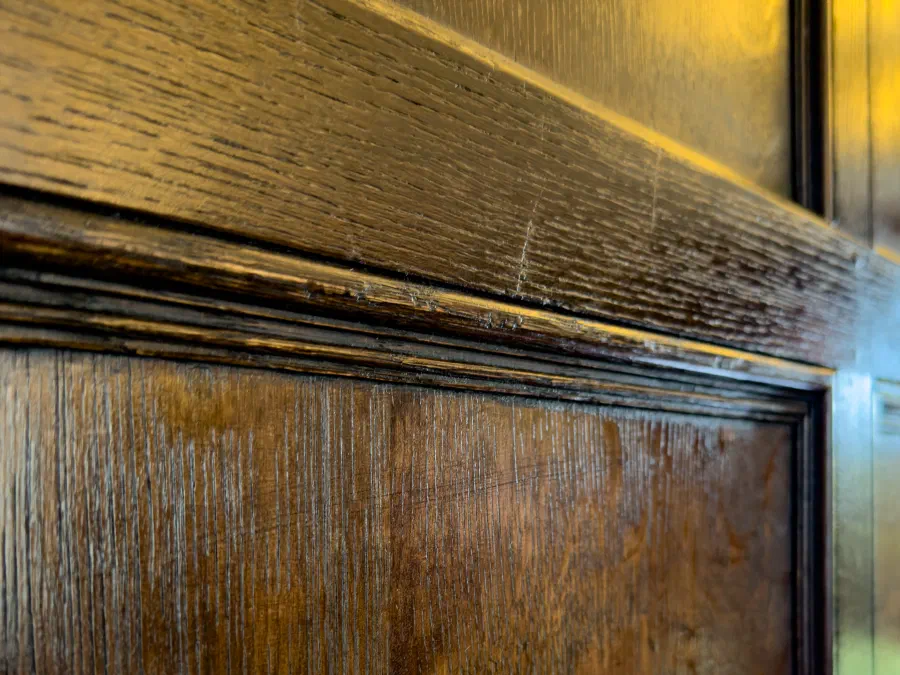 Close view of the finished surface and moulding detail on oak panelling