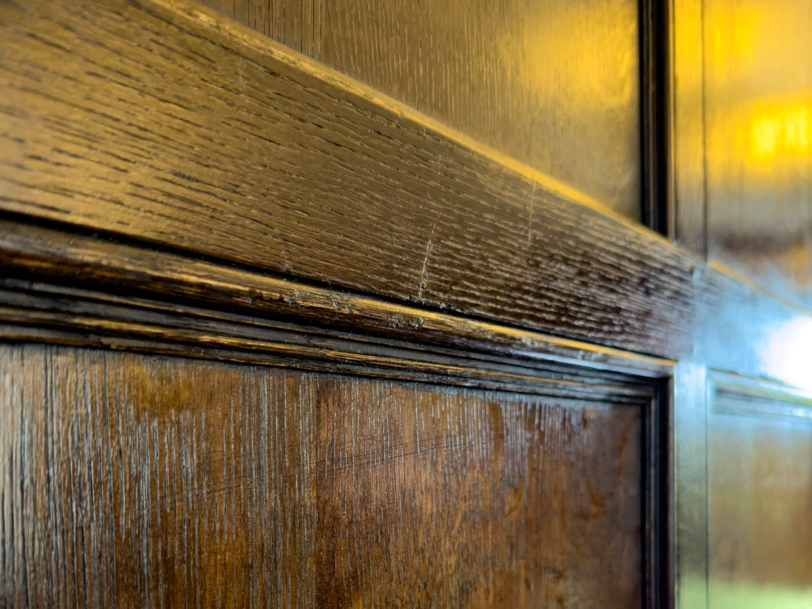 Close view of the finished surface and moulding detail on oak panelling