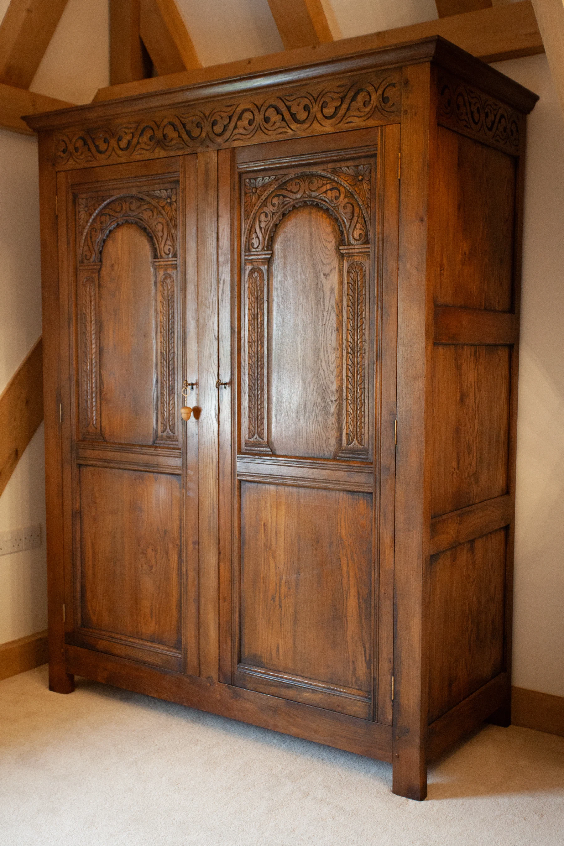 Oak cupboard with arched panelled doors