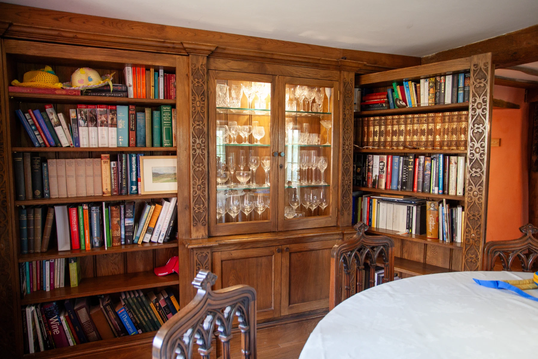 Fitted bookcases with a glazed display cabinet at their centre