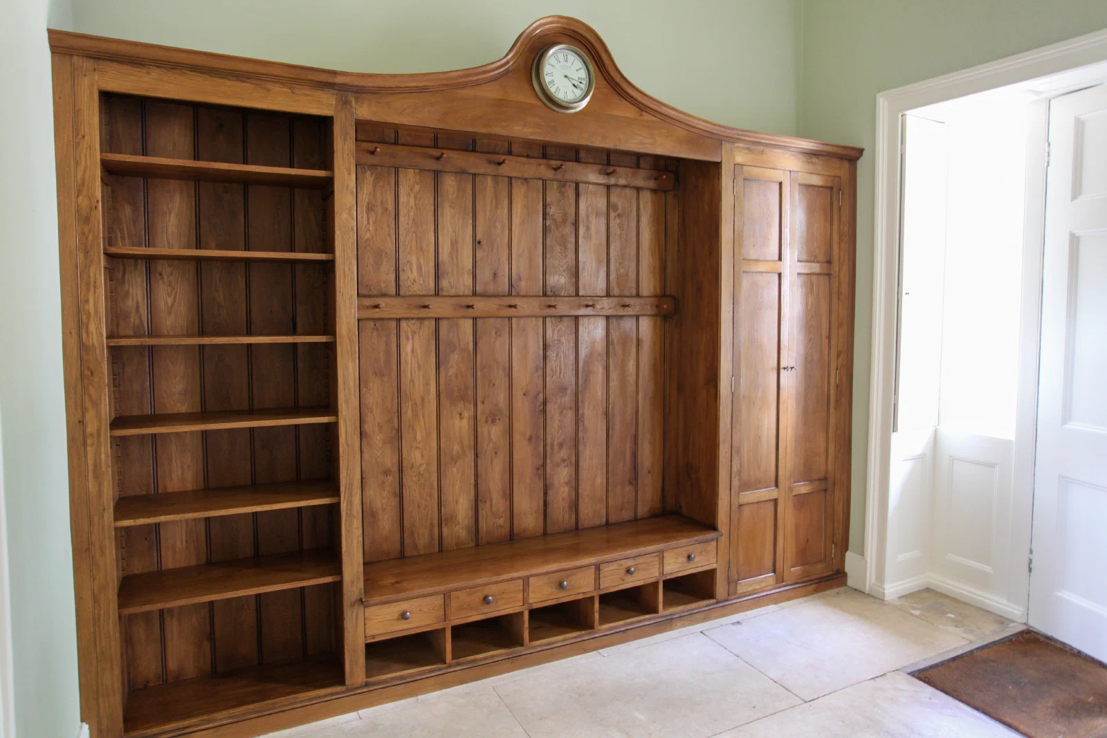 Boot room unit with open shelves, a panelled cupboard and a bench with space for boots beneath