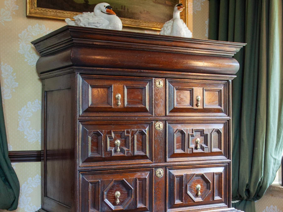 Cabinet with panelled drawers on a turned stand