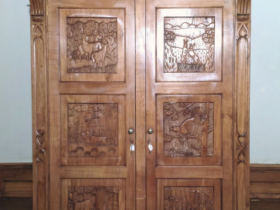 Carved oak cupboard with panelled doors