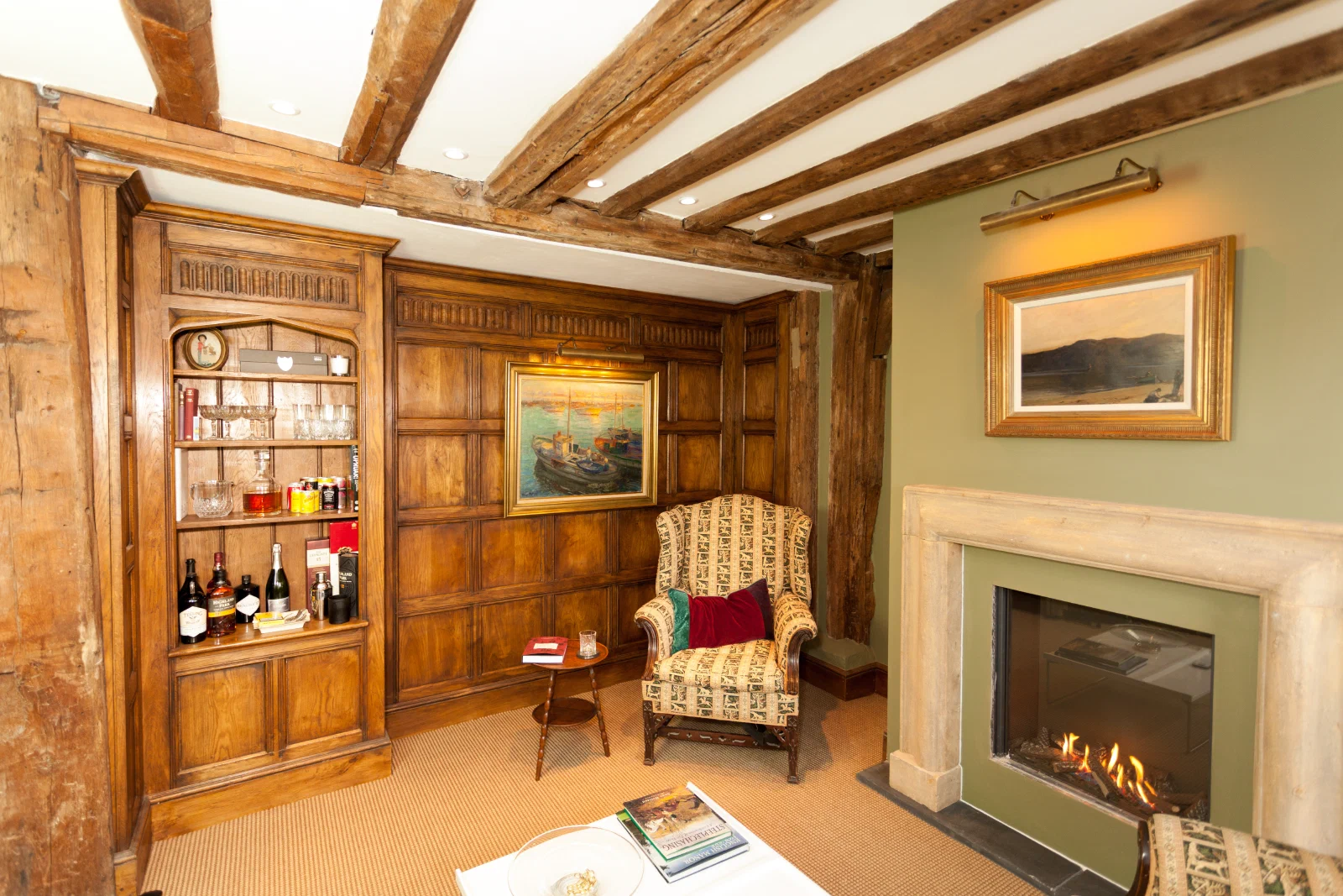 Oak shelving and cupboards fitted into a niche beside the fireplace