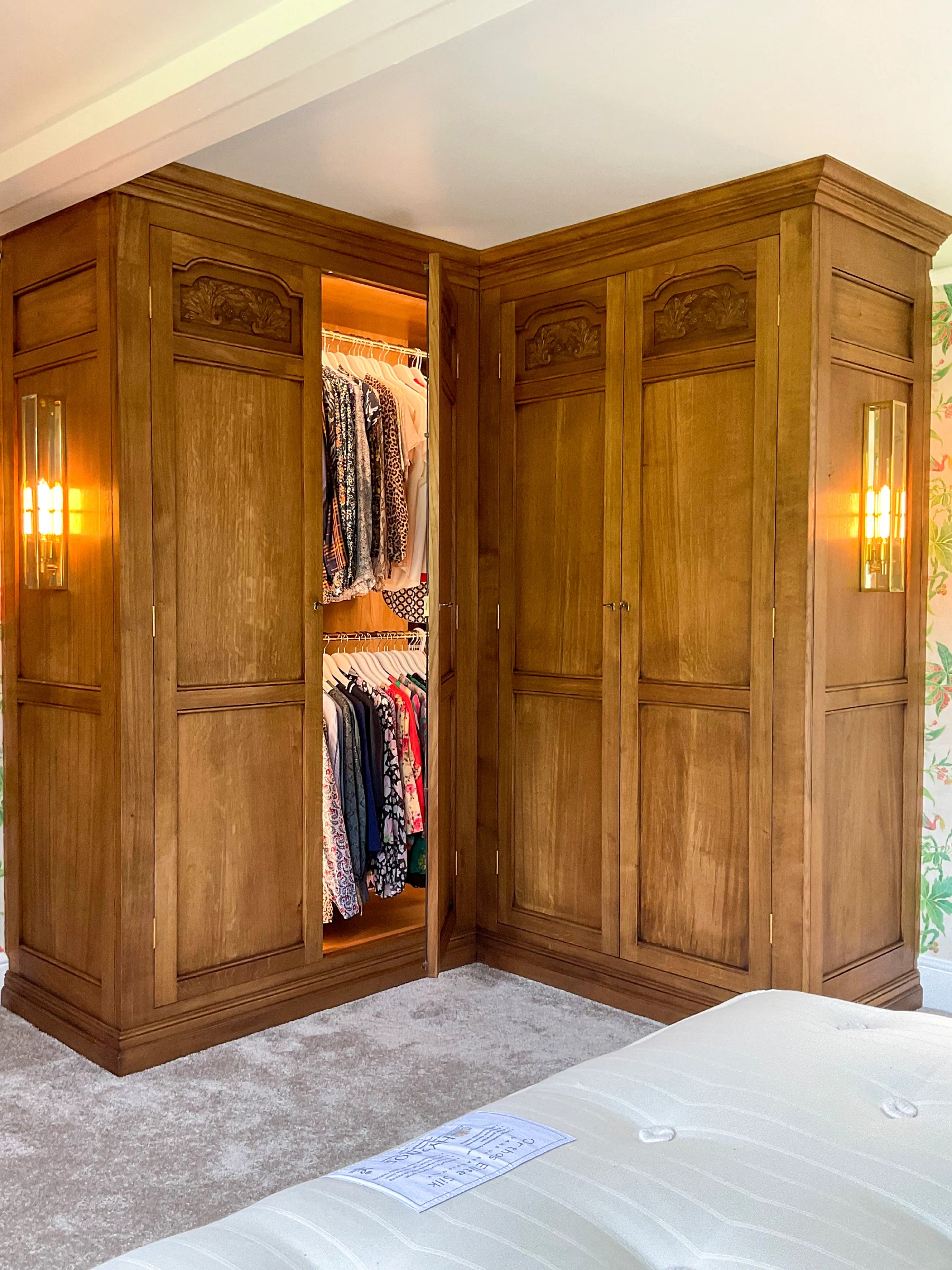 Fitted wardrobes with lit interiors and hanging space