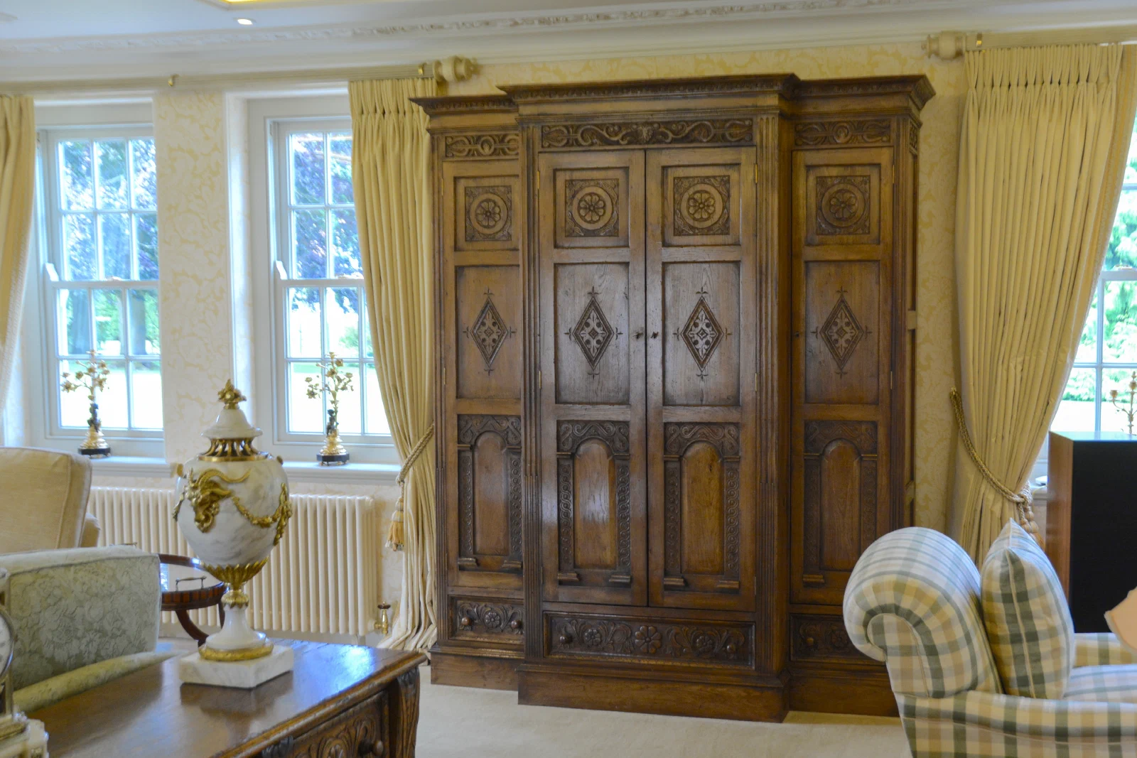 Illuminated oak display cabinet fitted into the panelling at Old Oak Hall