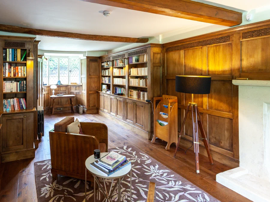 Fitted oak bookcases with a tripod reading lamp