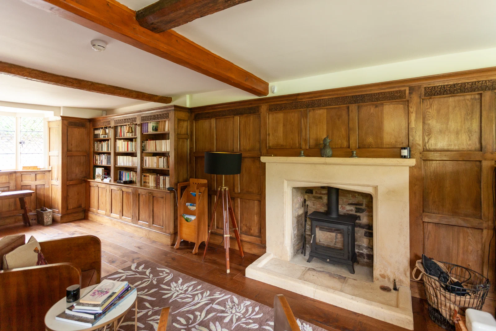 Oak bookcases fitted beside a stone fireplace