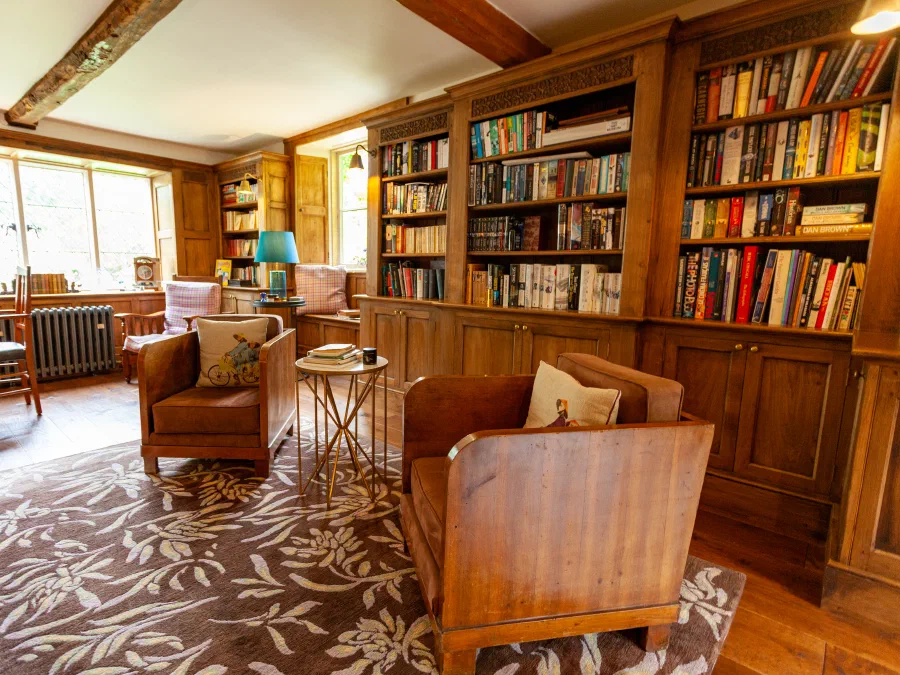 Wide view of the oak library with bookcases on several walls