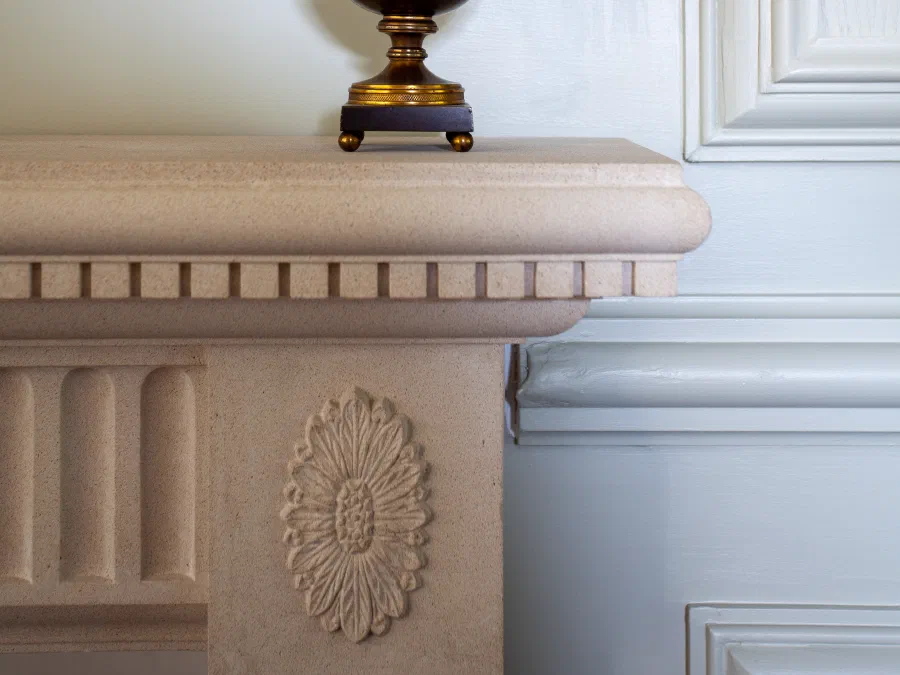 Painted panelling and chimneypiece detail with an urn on the mantel