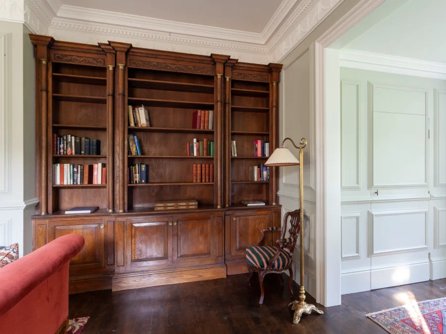 Panelled jib doors beside an oak bookcase