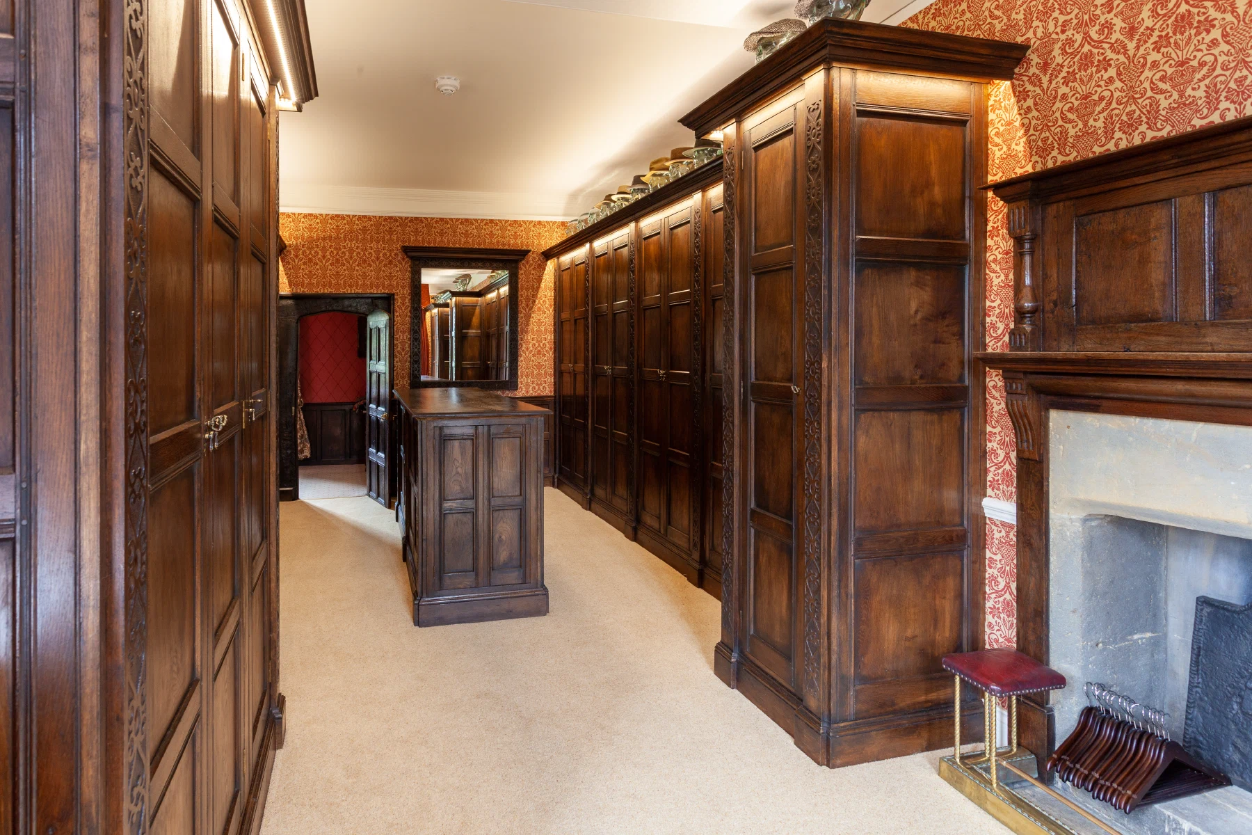 Long view through the Halstock Court dressing room with central island and wardrobes