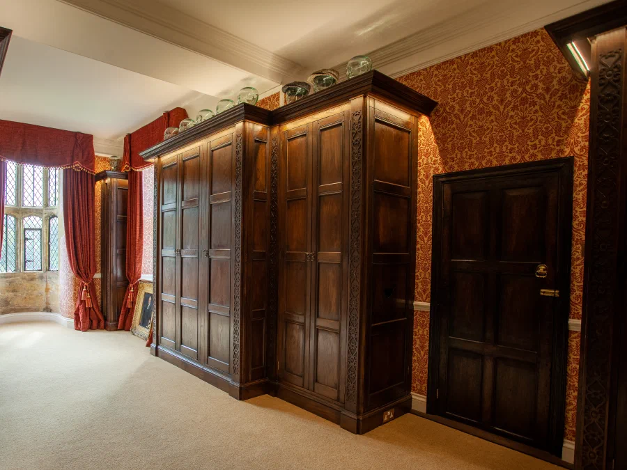 Panelled wardrobes and a doorway on the window wall