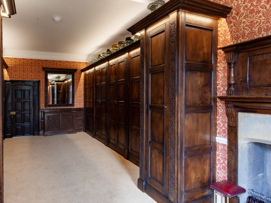 Panelled wardrobes either side of a fireplace