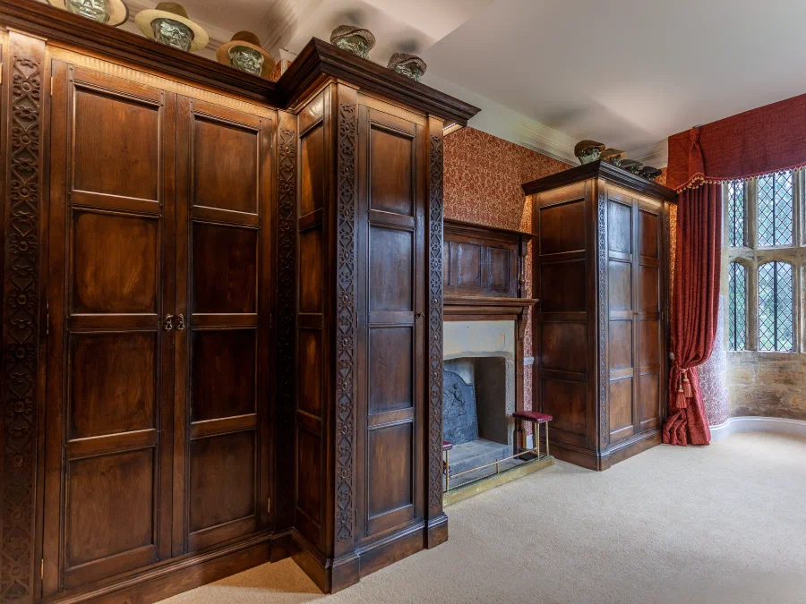 Run of panelled wardrobes towards the window bay