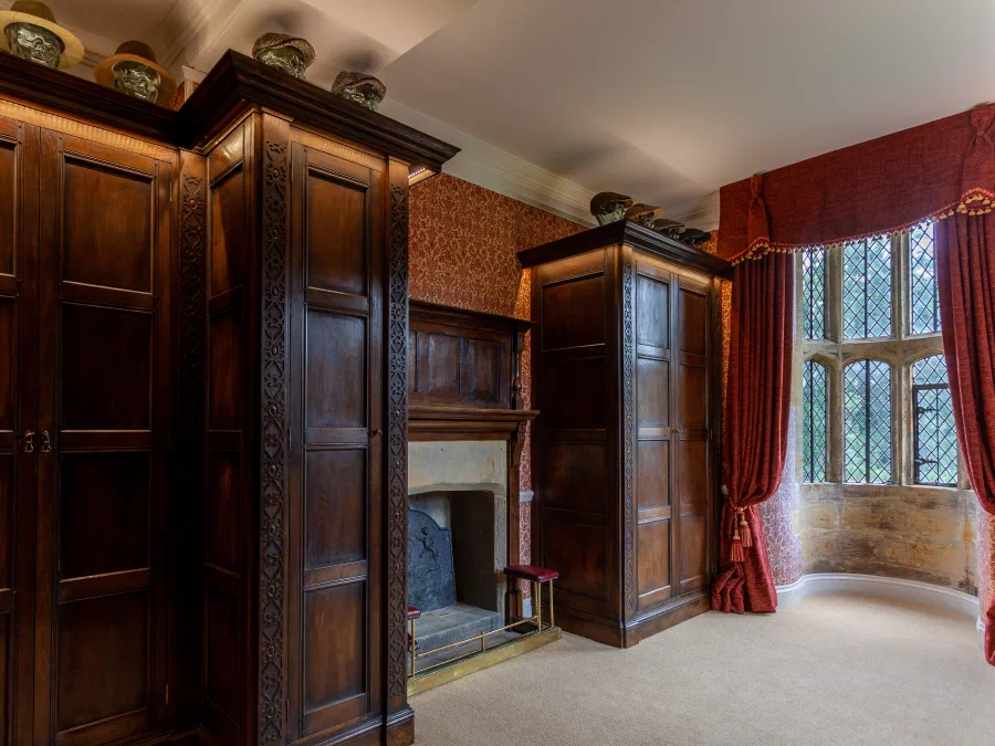Tall panelled wardrobe doors beside a window