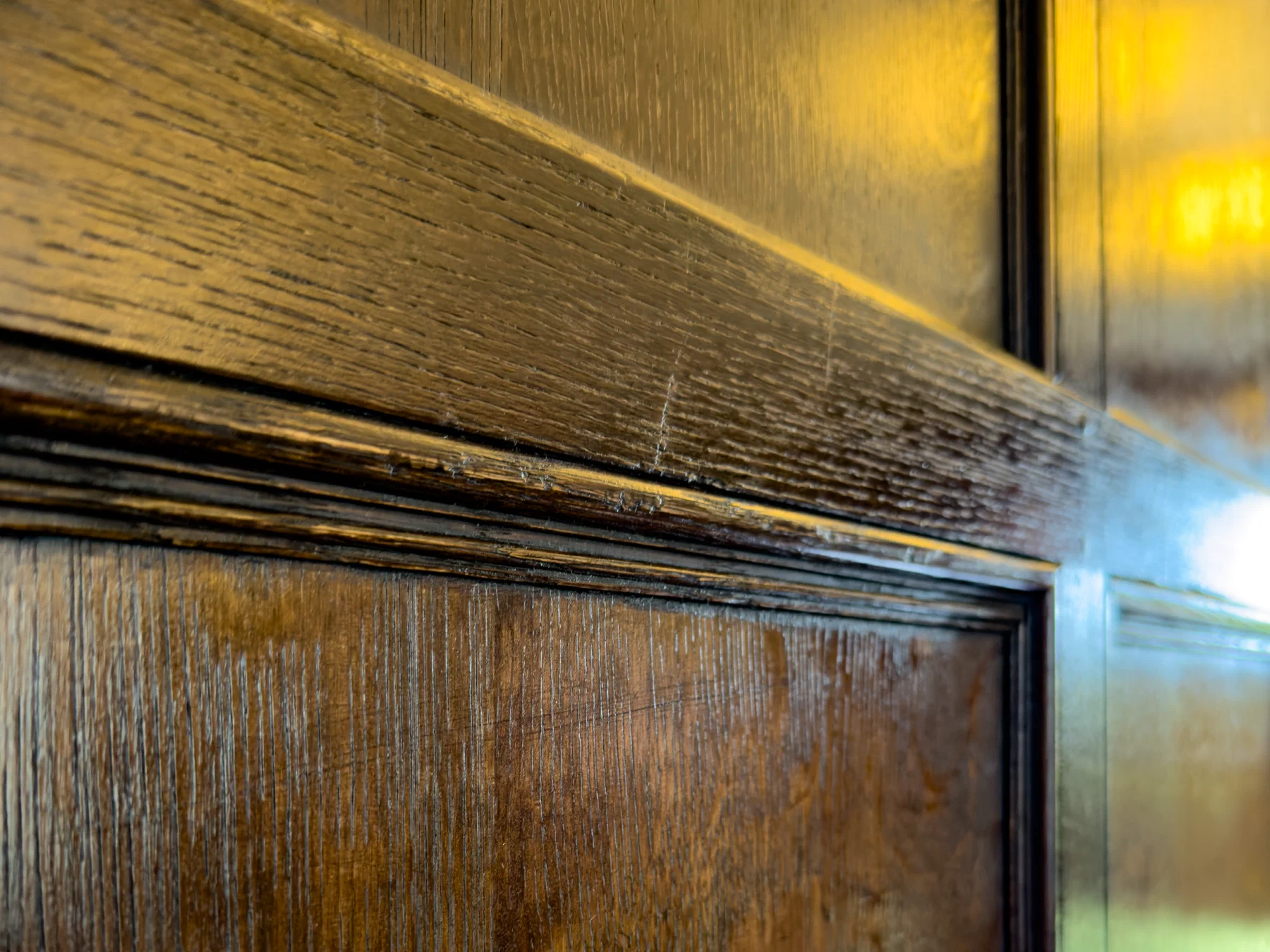 Close view of the dark finish across a panel moulding