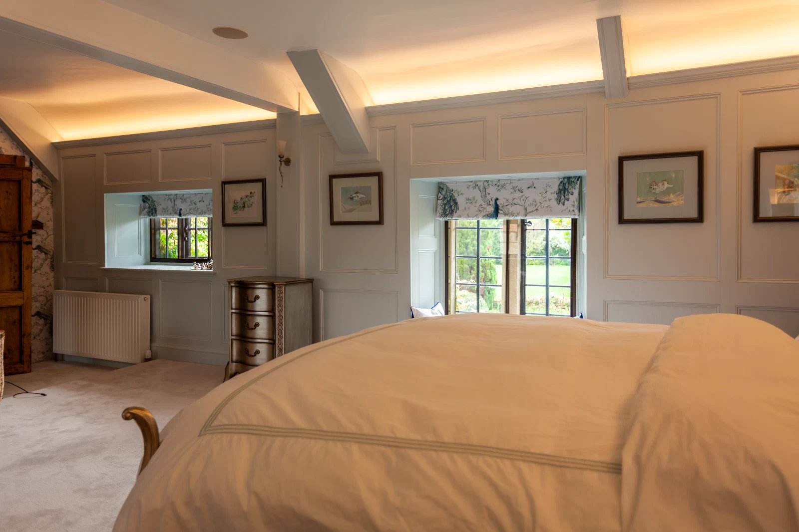 Blue painted bedroom panelling with wall lights