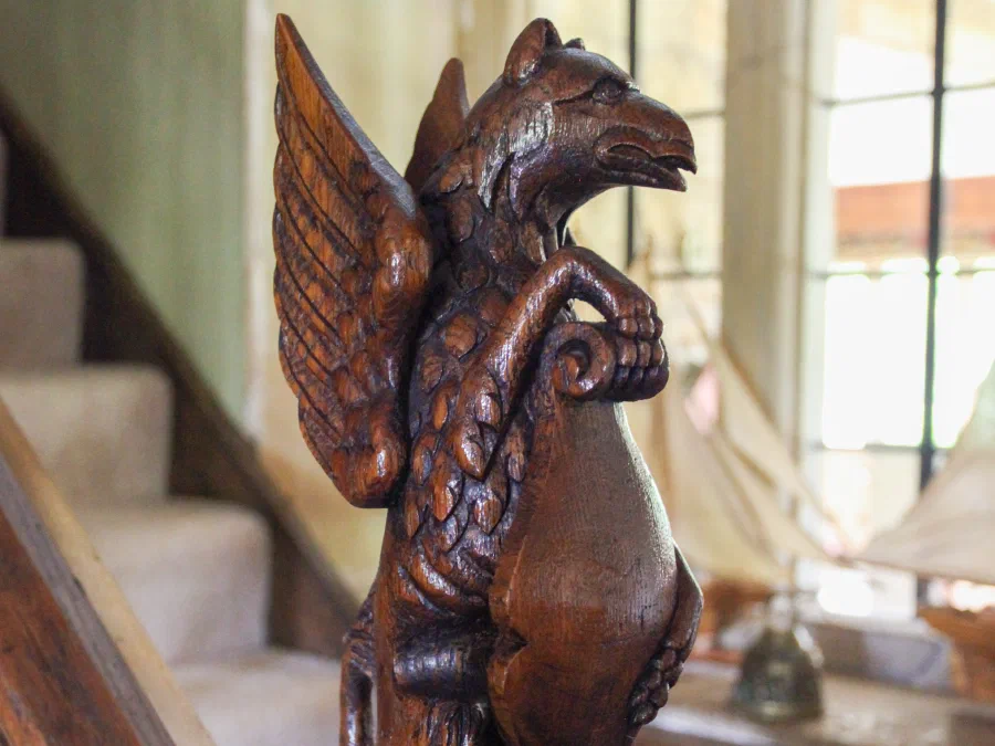 Close view of the carved figure on the oak newel post