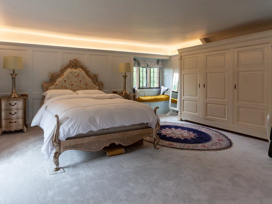Painted panelling and fitted cupboards in the bedroom