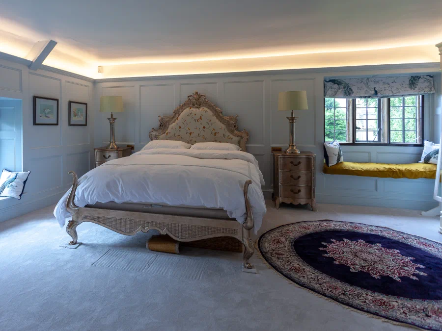 Painted panelled bedroom at Little Peacock Cottage