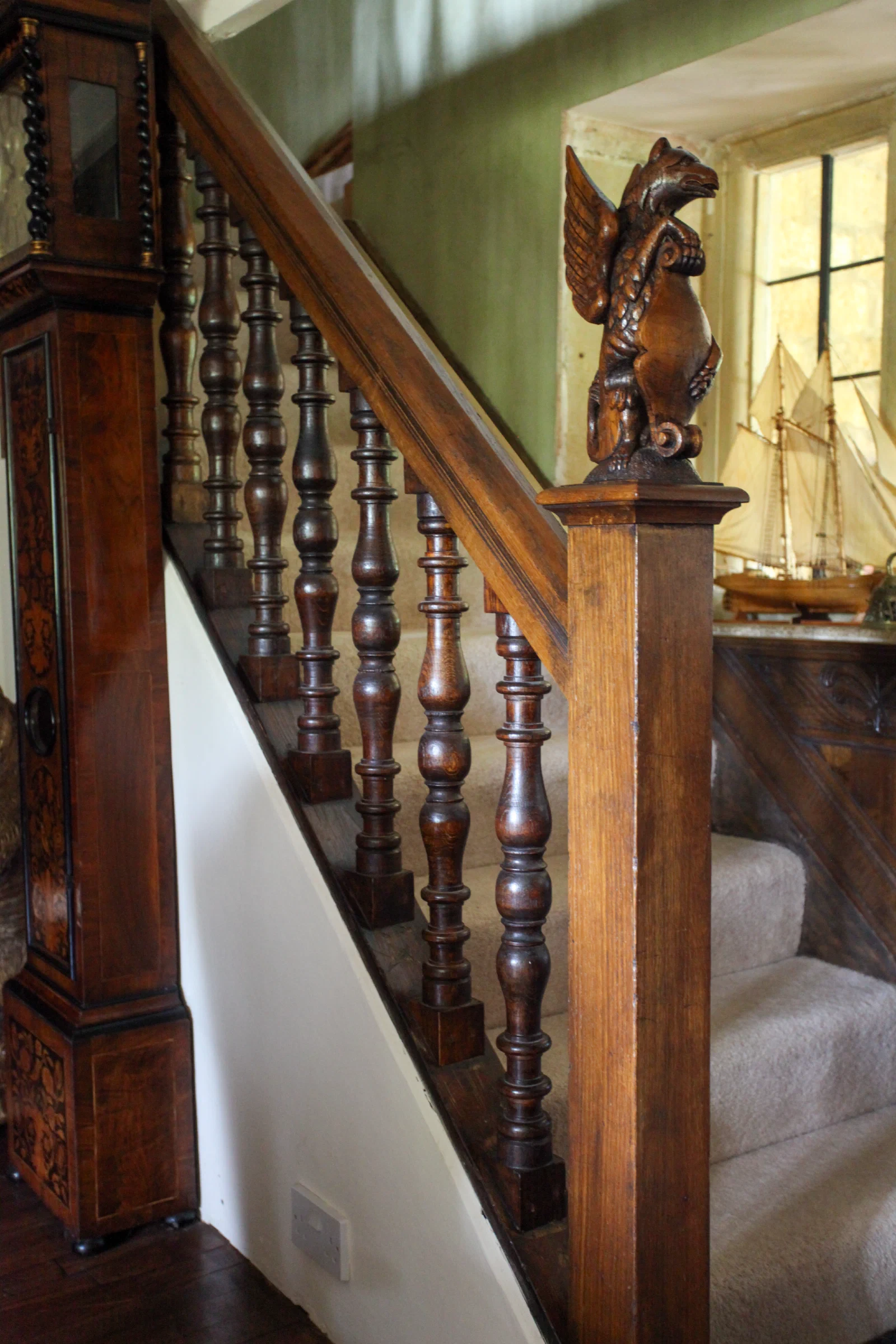 Oak staircase with a carved figure on the newel post