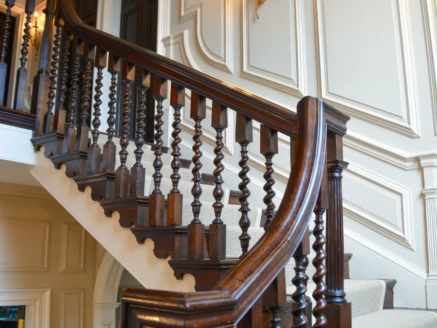 Painted panelling rising beside the staircase