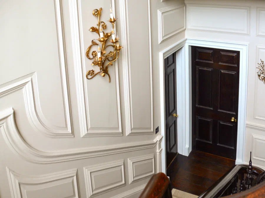 Shaped painted panels following the rise of the stair at Marwood House