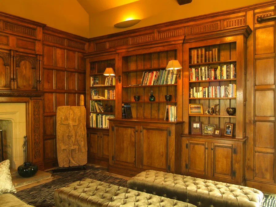 Oak bookcases built into the panelled walls of the Great Hall