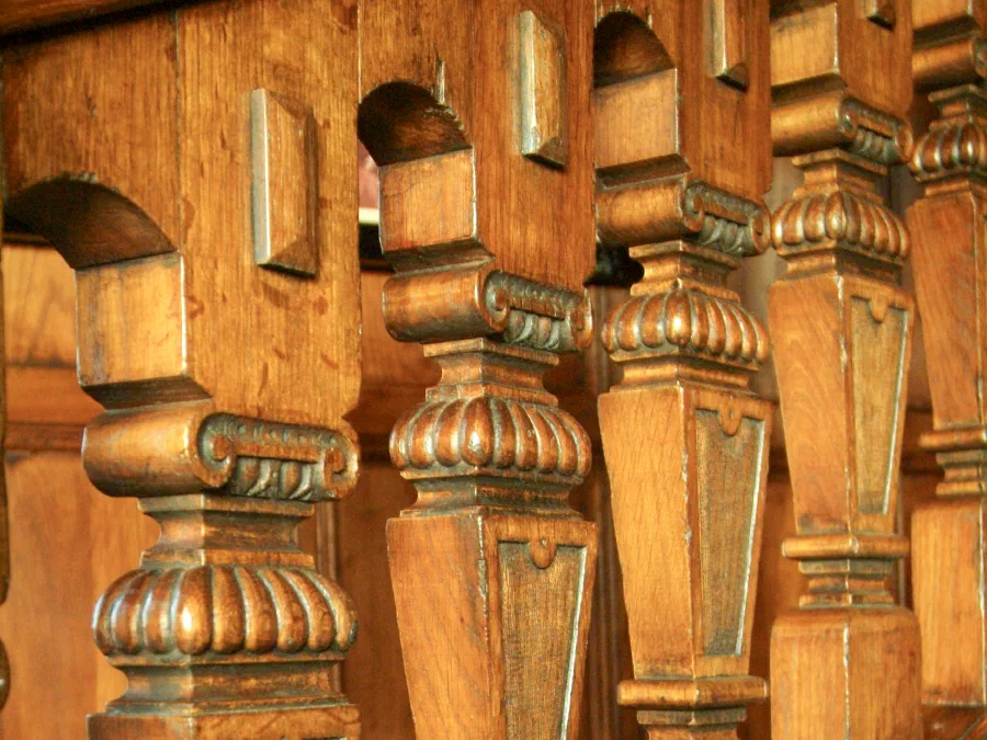 Close view of hand-carved square oak balusters on the Great Hall staircase