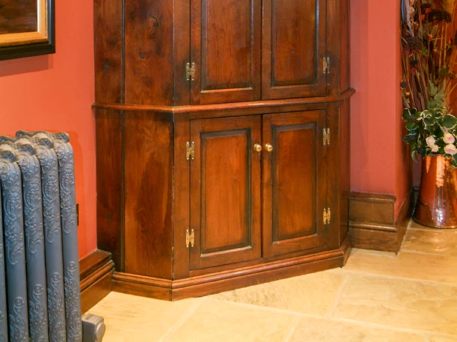 Tall two-stage oak corner cupboard with panelled doors