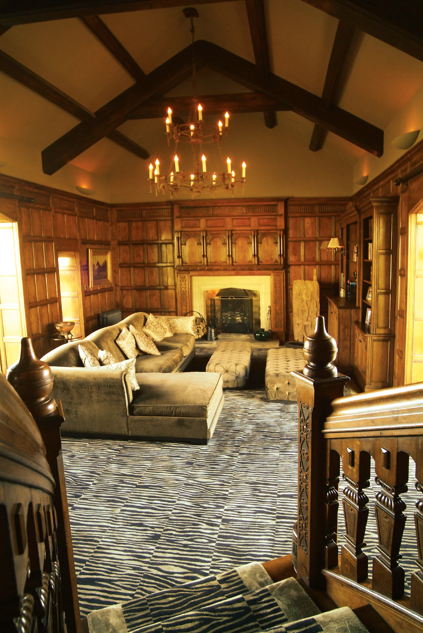 Oak-panelled Great Hall with entrance doors and carved pilasters