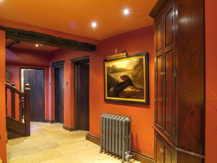 Hallway with planked oak doors and a stone floor