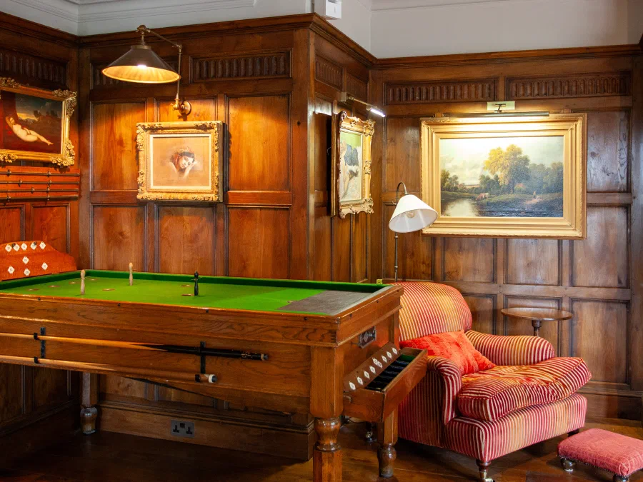 Oak panelling and framed pictures above the games table