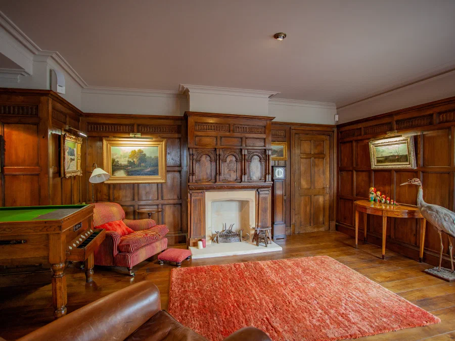 Wide view of the oak-panelled room