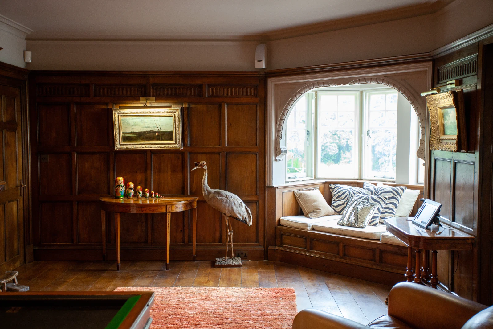 Oak panelling with a hand-carved frieze rail and integrated window seat