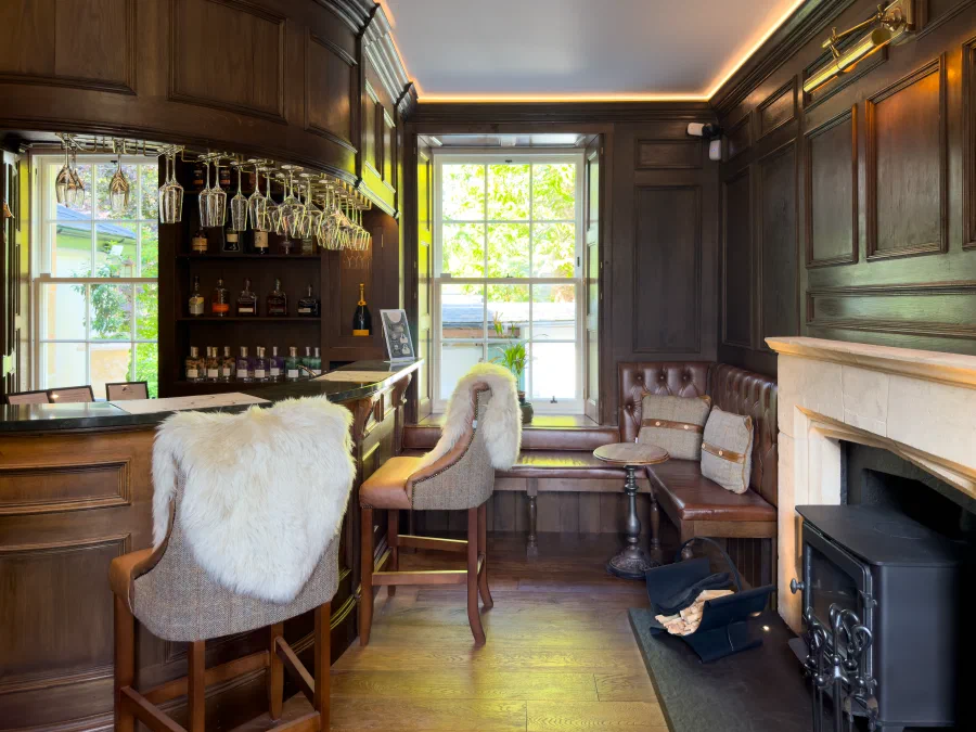 Curved bar and stools with the fireplace beyond