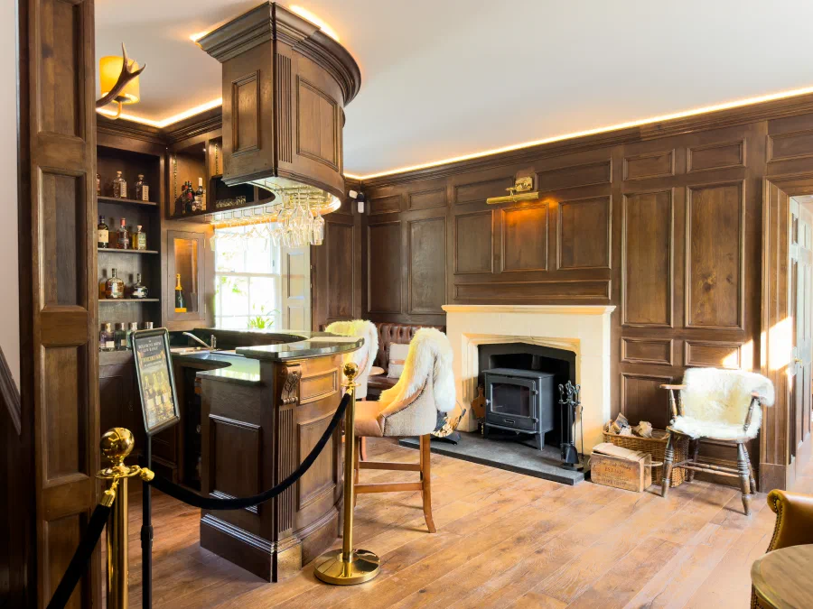 Whisky bar room with the bar, fireplace and seating