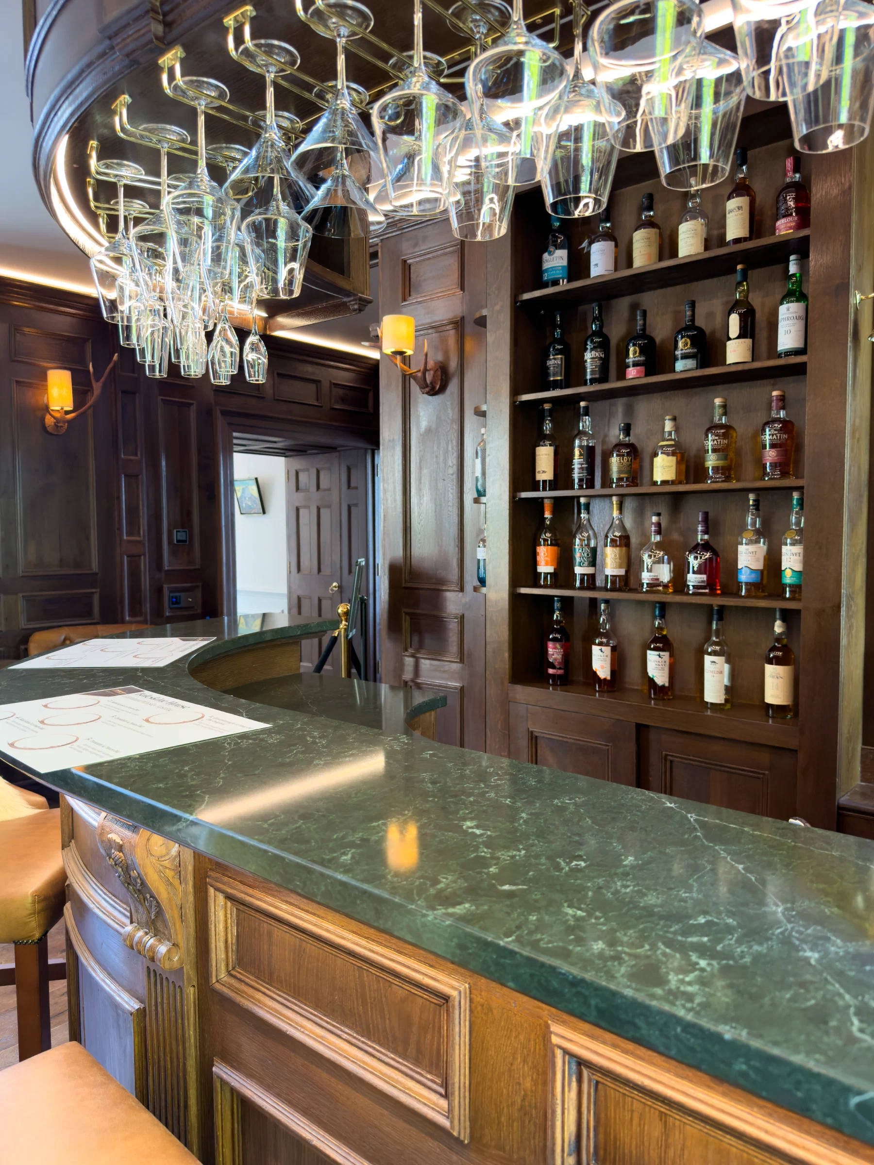 Working side of the bar with glassware and open shelving