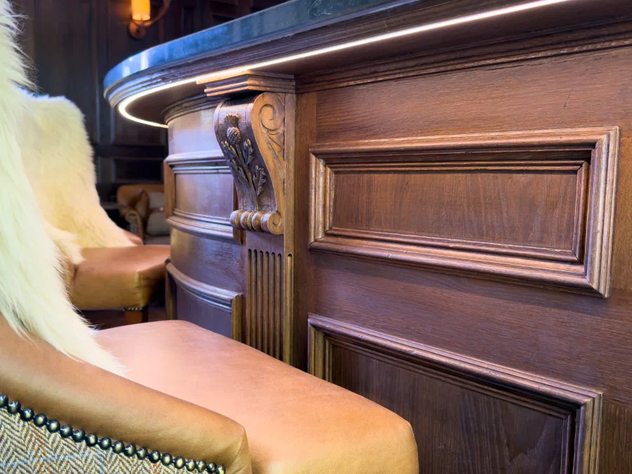 Close view of the panelled front of the curved bar