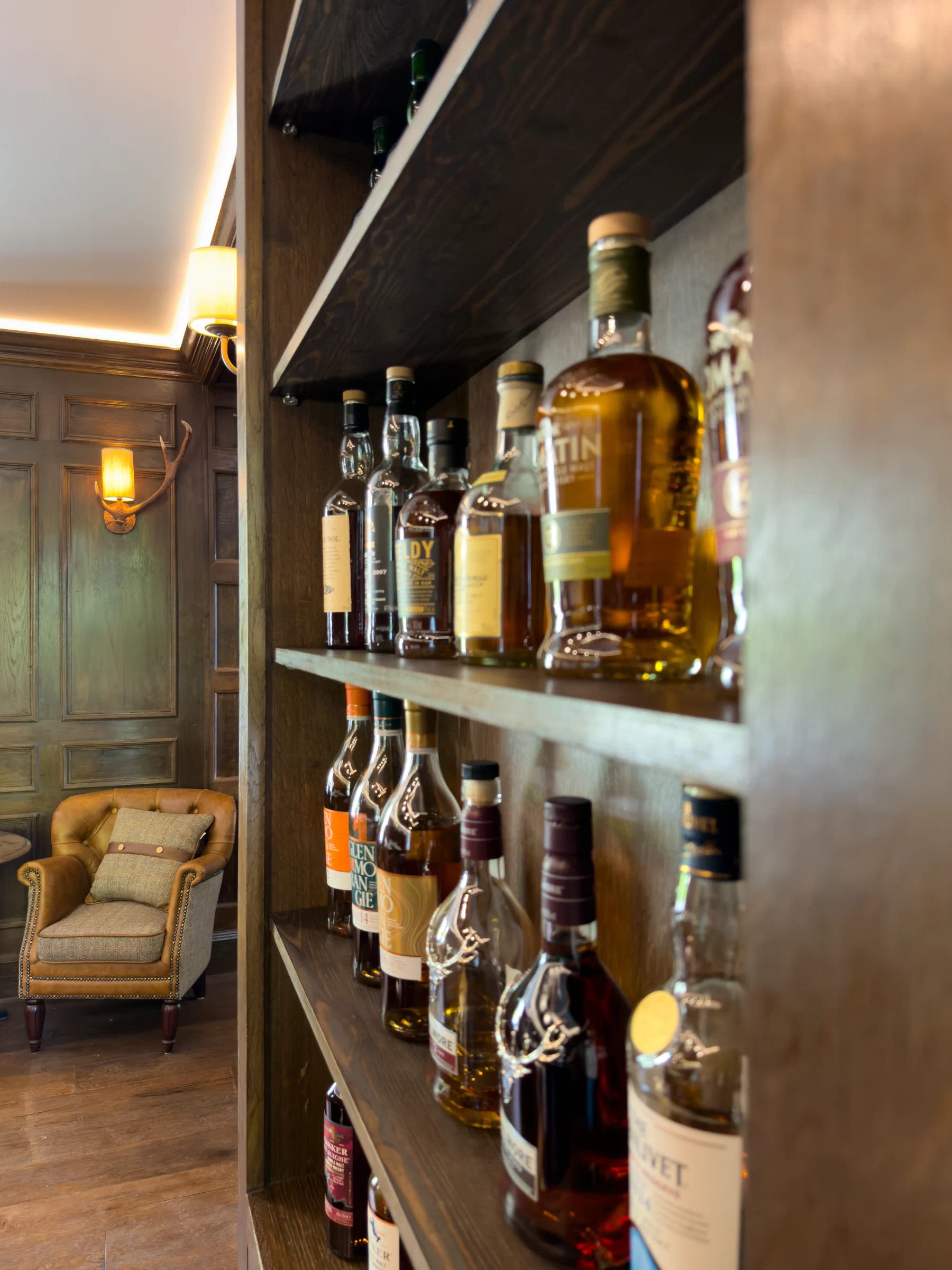 Illuminated shelves of whisky bottles