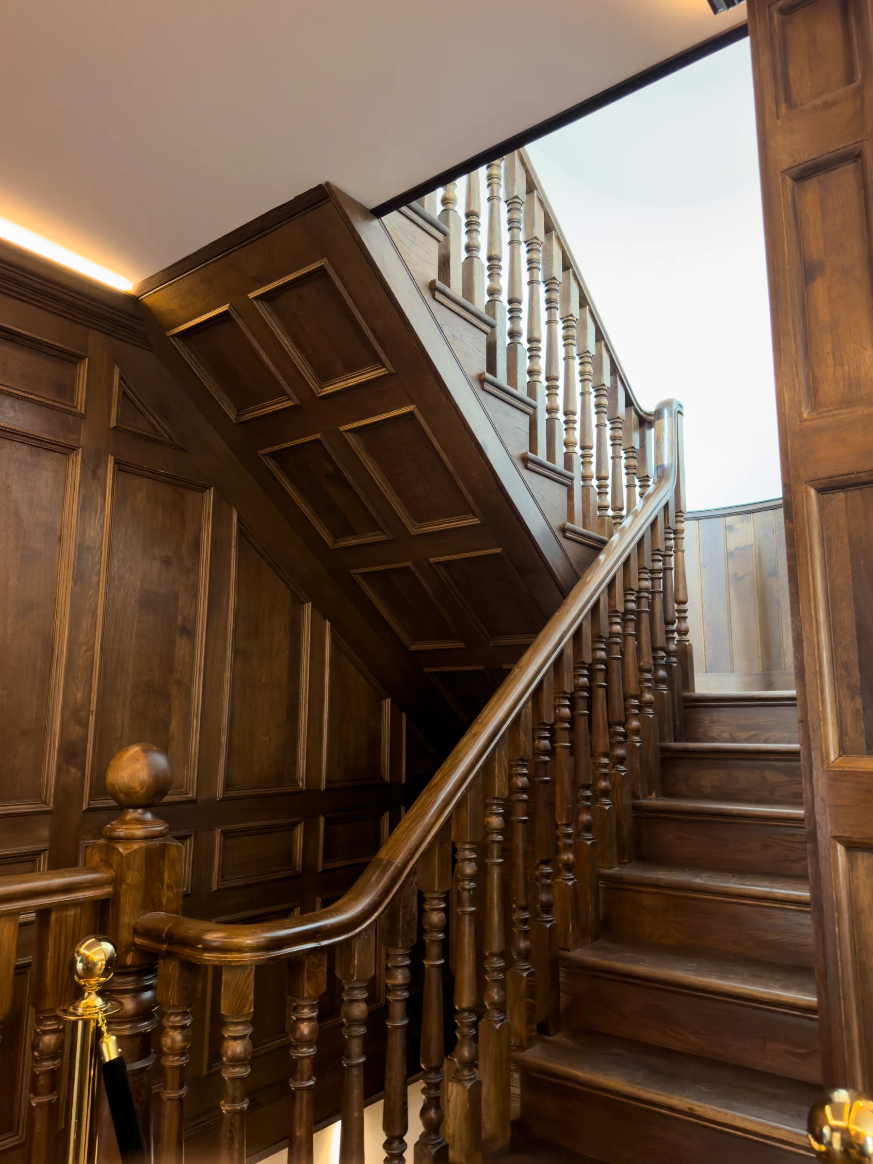 Oak-panelled staircase adjoining the whisky bar