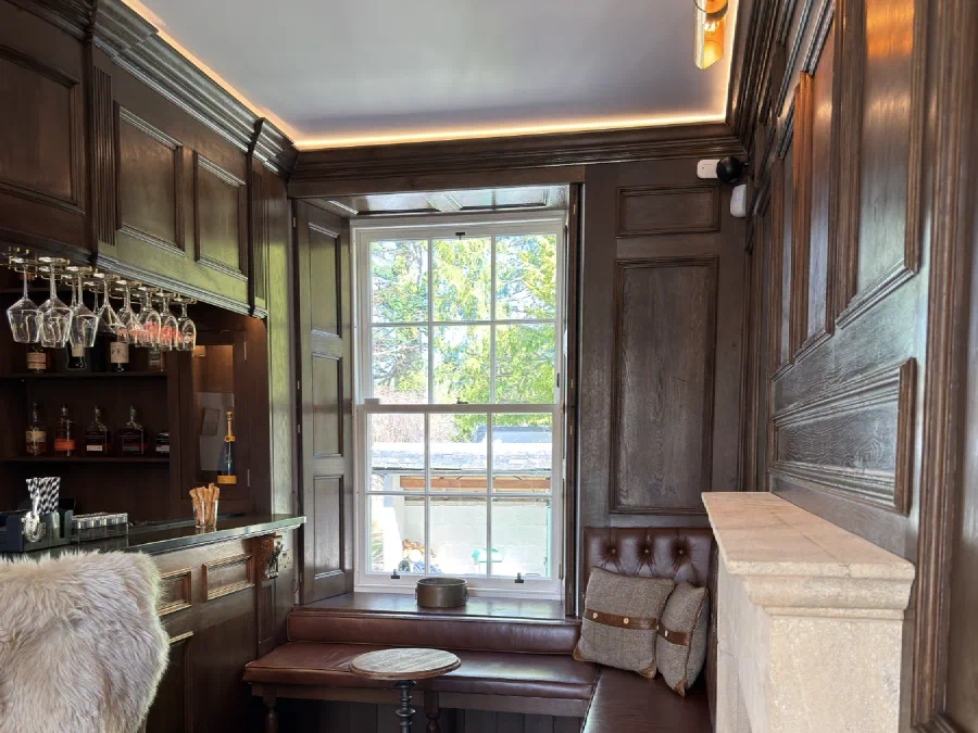 Window seat, shutters and dark oak panelling