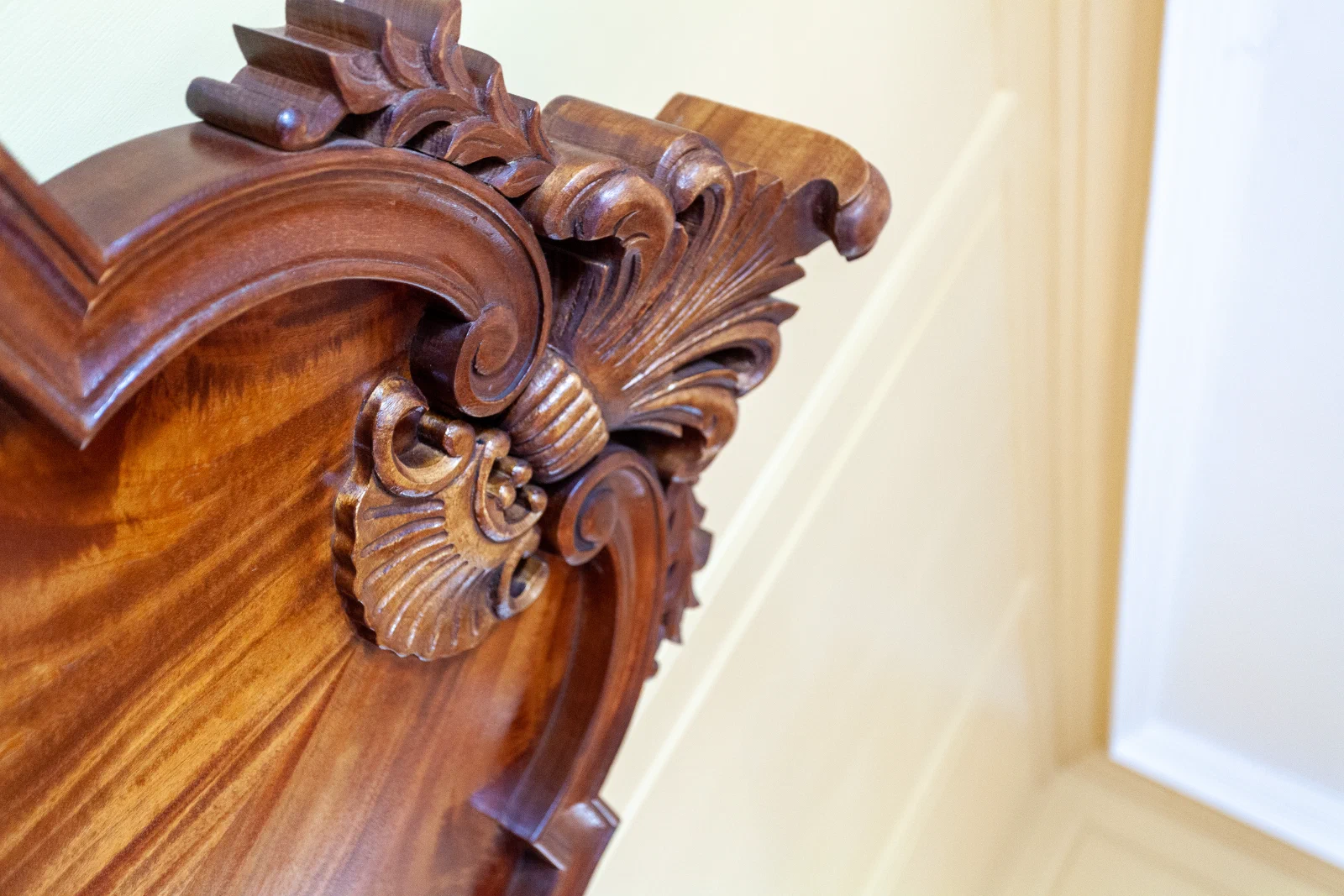 Close view of carved detail on the mahogany headboard