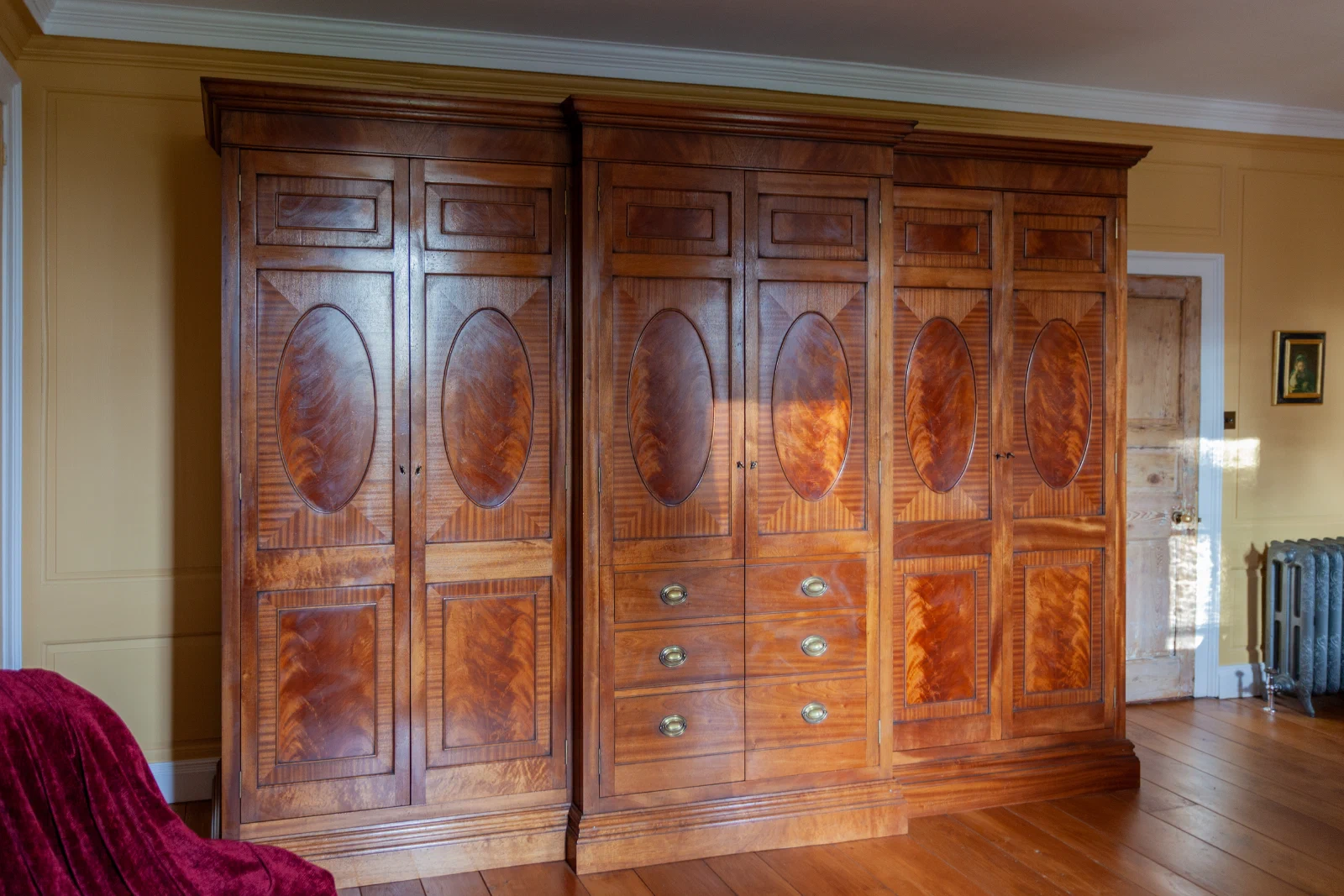 Breakfront mahogany wardrobe with flame-figured panels and false drawer fronts