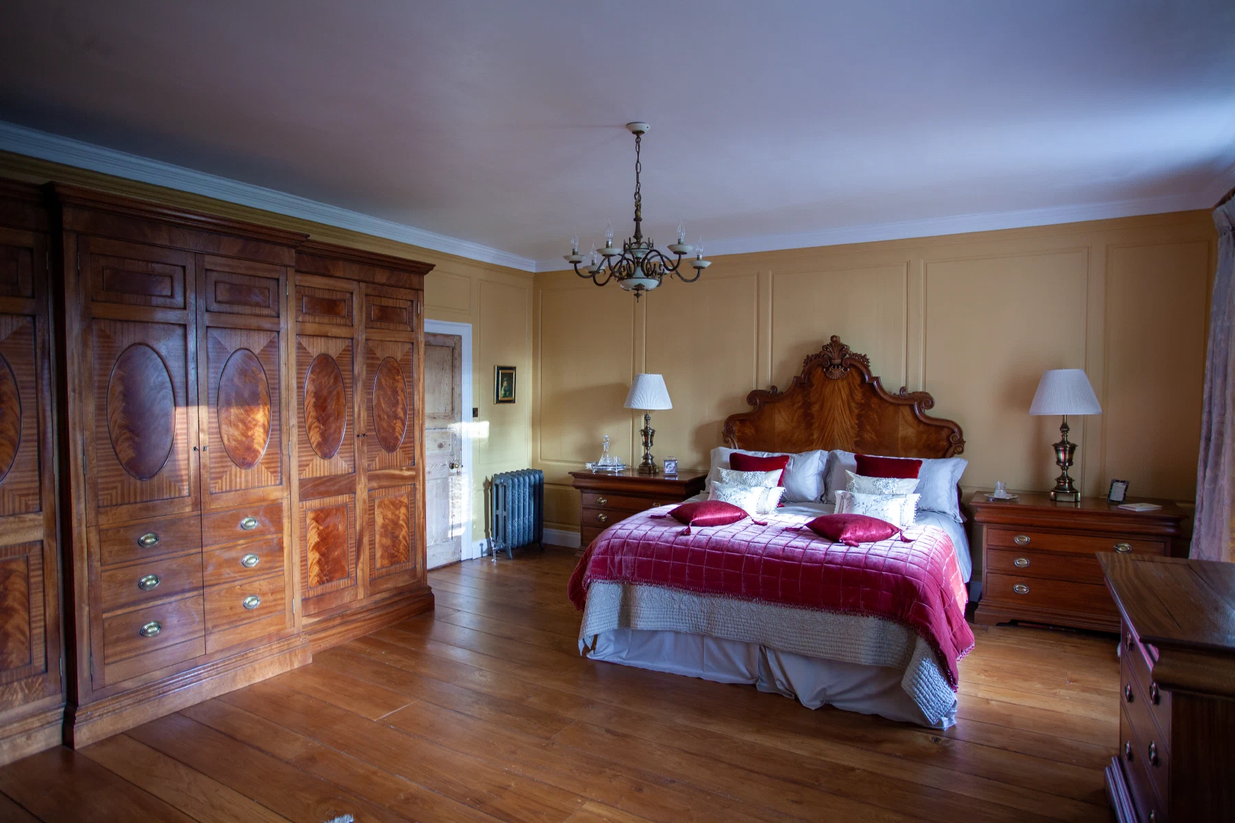 Mahogany bedroom furniture against the restored pine panelling