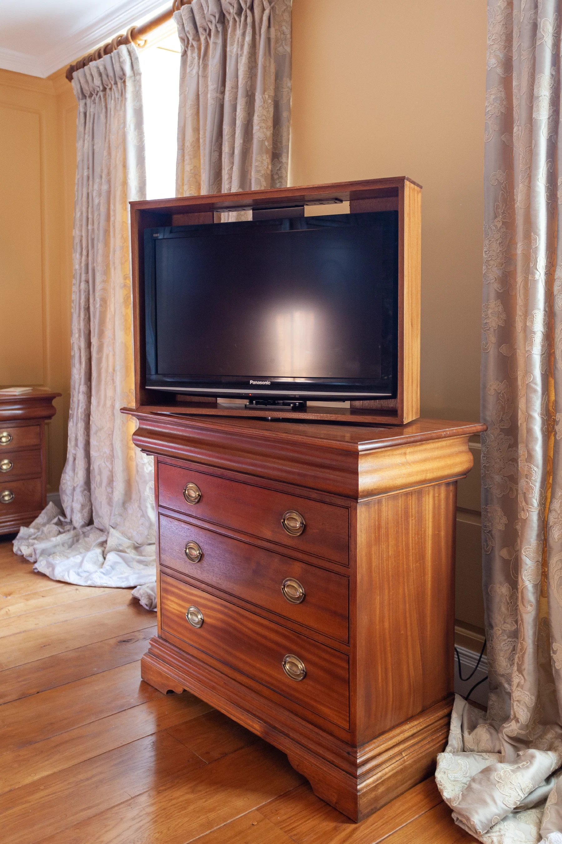 Mahogany television cabinet with the lift extended